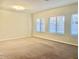 Bright and airy living room with neutral carpeting at 15685 W Mackenzie Dr, Goodyear, AZ 85395