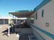 Mobile home with covered patio and desert landscaping at 201 S Greenfield Rd # 197, Mesa, AZ 85206