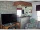 Living room with a stone accent wall and flat-screen TV at 201 S Greenfield Rd # 197, Mesa, AZ 85206