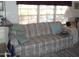 Living area showcasing a floral patterned sofa and side table at 201 S Greenfield Rd # 197, Mesa, AZ 85206