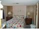 Cozy bedroom with a patchwork quilt and wooden nightstands at 201 S Greenfield Rd # 197, Mesa, AZ 85206