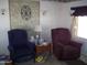 Living area with armchairs and stone accent wall at 201 S Greenfield Rd # 197, Mesa, AZ 85206