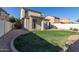 Home's backyard with grassy area and covered patio at 40375 W Helen Ct, Maricopa, AZ 85138