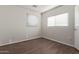 Simple bedroom with wood-look flooring and window blinds at 8834 S 12Th St, Phoenix, AZ 85042