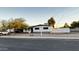 White single story house with a landscaped front yard and a white fence at 2207 E Aspen Ave, Mesa, AZ 85204