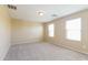 Bright bedroom with two windows and neutral walls at 42564 W Palmyra Ln, Maricopa, AZ 85138