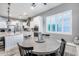 Bright kitchen with granite countertops, white cabinets, and a center island at 10304 W Pinnacle Vista Dr, Peoria, AZ 85383