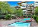 Community pool and spa with lounge chairs at 7121 E Rancho Vista Dr # 4004, Scottsdale, AZ 85251