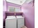 Laundry room with washer, dryer, and purple walls at 1534 E Oak Rd, San Tan Valley, AZ 85140