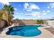 Inviting kidney-shaped pool with a diving board and rock landscaping at 1534 E Oak Rd, San Tan Valley, AZ 85140