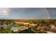 Aerial view of community with lake and pool, rainbow visible at 41906 W Solitare Dr, Maricopa, AZ 85138