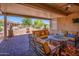 Large covered patio with seating area and fire pit, ideal for relaxation at 41906 W Solitare Dr, Maricopa, AZ 85138