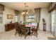 Bright dining room with wood table and access to the kitchen at 41906 W Solitare Dr, Maricopa, AZ 85138