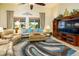 Living room features plush seating, area rug, and ceiling fan at 41906 W Solitare Dr, Maricopa, AZ 85138
