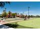 Landscaped bocce ball court and seating area in community at 41906 W Solitare Dr, Maricopa, AZ 85138