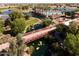 Arial view of community with lake, bridge and landscaping at 41906 W Solitare Dr, Maricopa, AZ 85138