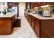 Spacious kitchen with granite countertops, stainless steel appliances, and dark wood cabinetry at 41906 W Solitare Dr, Maricopa, AZ 85138