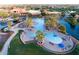 Large resort-style pool with surrounding seating and palm trees at 41906 W Solitare Dr, Maricopa, AZ 85138