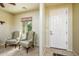 Bright and airy entryway with two wingback chairs and tiled flooring at 41906 W Solitare Dr, Maricopa, AZ 85138