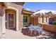 Relaxing patio with white metal furniture and umbrella at 41906 W Solitare Dr, Maricopa, AZ 85138