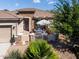 Front view of home with inviting patio and wrought-iron gate at 41906 W Solitare Dr, Maricopa, AZ 85138