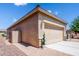 Attached two-car garage with decorative lighting at 41906 W Solitare Dr, Maricopa, AZ 85138