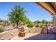 Relaxing backyard patio with fountain and seating area, perfect for outdoor entertaining at 41906 W Solitare Dr, Maricopa, AZ 85138