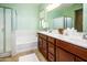 Bathroom with double vanity, soaking tub, and walk-in shower at 41906 W Solitare Dr, Maricopa, AZ 85138