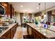 Open kitchen with island, breakfast nook, and view to backyard at 41906 W Solitare Dr, Maricopa, AZ 85138