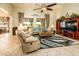 Spacious living room with comfortable seating and a large TV at 41906 W Solitare Dr, Maricopa, AZ 85138