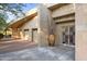 Contemporary home exterior with double garage doors and a large stone planter at 6301 N 51St Pl, Paradise Valley, AZ 85253