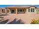 Home's back exterior showcasing patio and landscaping at 42915 W Kingfisher Dr, Maricopa, AZ 85138
