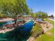 Serene community pond with lush landscaping at 42915 W Kingfisher Dr, Maricopa, AZ 85138
