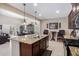 Open kitchen with an island, breakfast nook, and views to other rooms at 42915 W Kingfisher Dr, Maricopa, AZ 85138