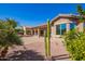 Home's back exterior with covered patio and landscaping at 42915 W Kingfisher Dr, Maricopa, AZ 85138