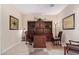 Bright home office features a large desk, built-in shelving, and two chairs at 42915 W Kingfisher Dr, Maricopa, AZ 85138