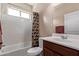 Clean bathroom with tub shower, vanity, and window at 42915 W Kingfisher Dr, Maricopa, AZ 85138