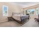 Bright bedroom with a comfortable bed and large windows at 42915 W Kingfisher Dr, Maricopa, AZ 85138