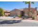 Tan two-story house with a three-car garage and desert landscaping at 42915 W Kingfisher Dr, Maricopa, AZ 85138