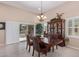 Elegant dining room with a large table, hutch, and chandelier at 42915 W Kingfisher Dr, Maricopa, AZ 85138