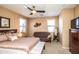 Spacious main bedroom with a king-size bed, dresser, and couch at 1265 S Aaron -- # 236, Mesa, AZ 85209