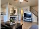 Open living room with kitchen island, stairs, and flat screen TV at 1213 E Lawrence Ln, Phoenix, AZ 85020