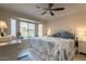 Main bedroom with a king-size bed, stylish bedding, and ample natural light at 14300 W Bell Rd # 222, Surprise, AZ 85374