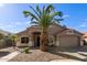 Tan house with a large palm tree in the front yard at 11431 E Pratt Ave, Mesa, AZ 85212