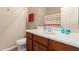 Bathroom with a single sink, toilet and striped shower curtain at 42424 N Gavilan Peak Pkwy # 50104, Anthem, AZ 85086