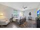 Main bedroom with king-size bed, wood floors, and ceiling fan at 2342 N Delaney Dr, Buckeye, AZ 85396