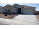 House exterior with a two-car garage and landscaped yard at 30893 W Pinchot W Ct, Buckeye, AZ 85396