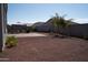 Spacious backyard with gravel, palm trees, and patio at 30893 W Pinchot W Ct, Buckeye, AZ 85396