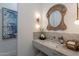 Elegant bathroom with marble vanity, ornate mirror, and artistic wall decor at 11250 W Prospector Dr, Queen Creek, AZ 85144