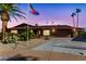 Inviting single-story home with a well-maintained front yard and palm trees at sunset at 12903 W Skyview Dr, Sun City West, AZ 85375